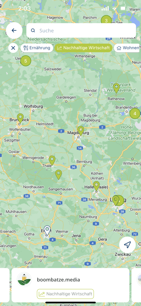 App screen showing the map view with an article panel about a sustainable company